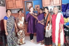 presenting Erica with one of their handmade necklaces